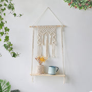 macrame plant hanger with wide shelf and tassel at the top