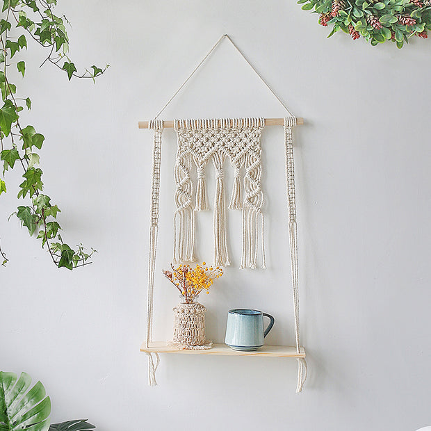 macrame plant hanger with wide shelf and tassel at the top