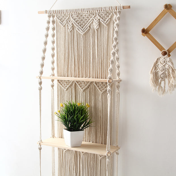 Macrame floating wall shelves with plant in the middle shelf