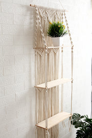 macrame floating wall shelves with plant at the top