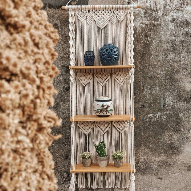 Macrame floating wall shelves with various items