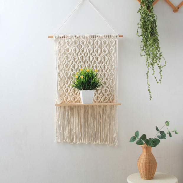 macrame shelf with pot of plant